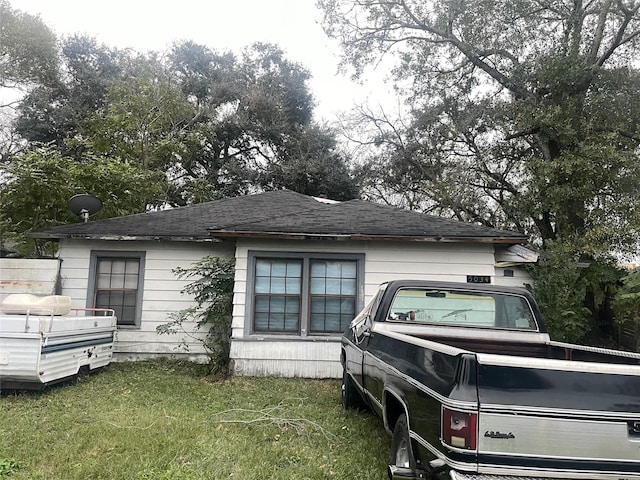 view of property exterior with a lawn