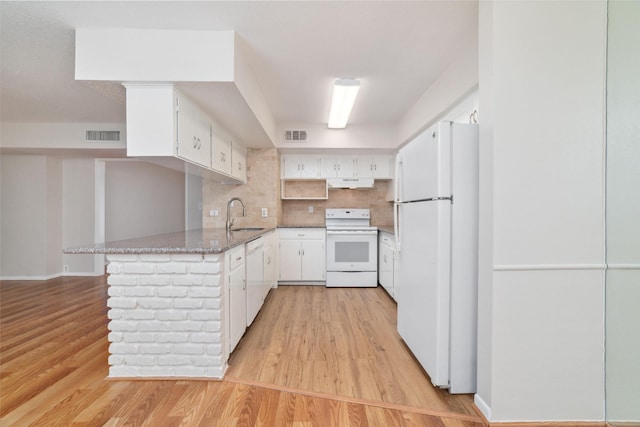 kitchen featuring white cabinetry, light stone countertops, sink, and white appliances