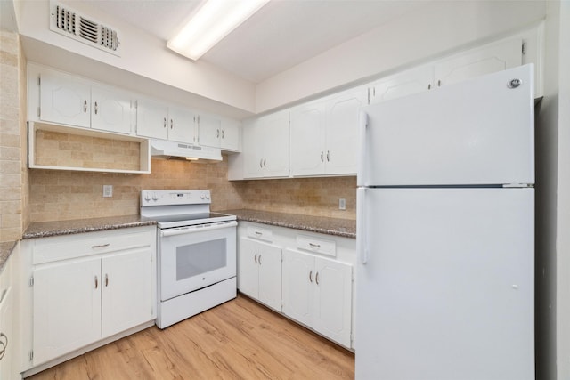 kitchen with white appliances, dark stone counters, white cabinets, and light wood-type flooring