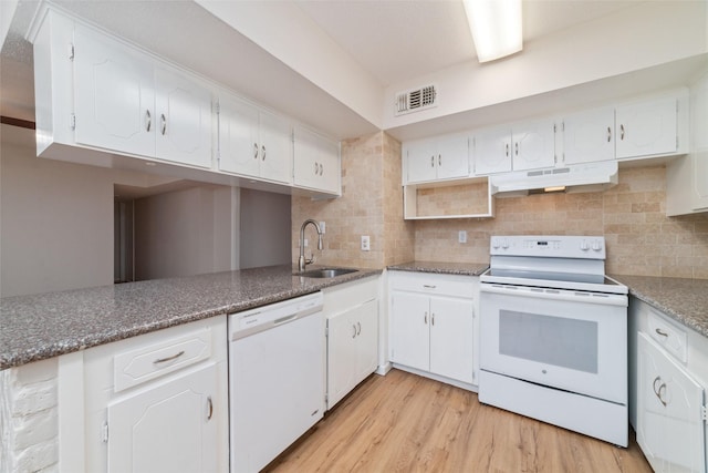 kitchen featuring white cabinetry, sink, white appliances, and backsplash