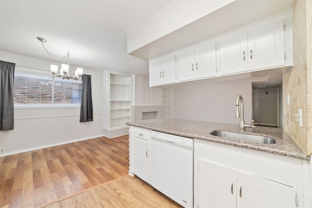 kitchen featuring sink, light hardwood / wood-style flooring, dishwasher, white cabinetry, and hanging light fixtures