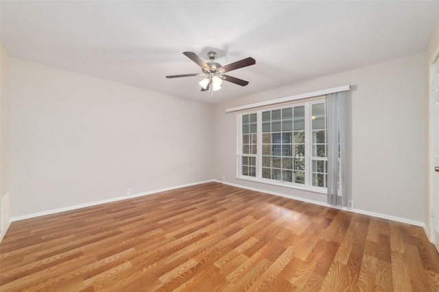 empty room with ceiling fan and light hardwood / wood-style flooring