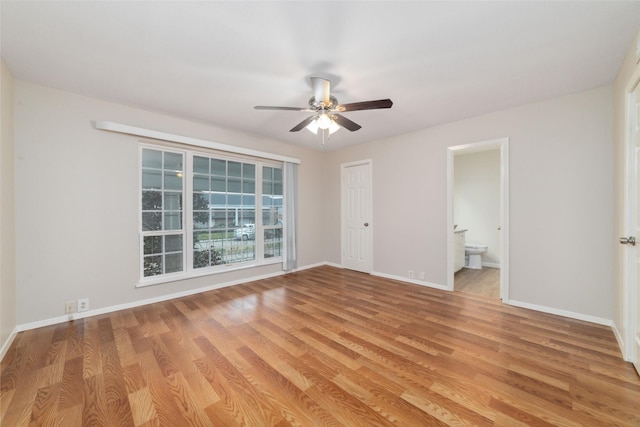 unfurnished bedroom with ceiling fan, ensuite bath, and light hardwood / wood-style flooring