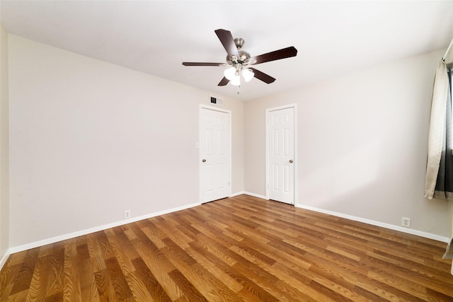 spare room with hardwood / wood-style flooring and ceiling fan