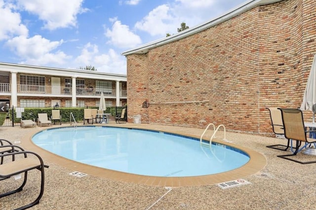 view of swimming pool with a patio