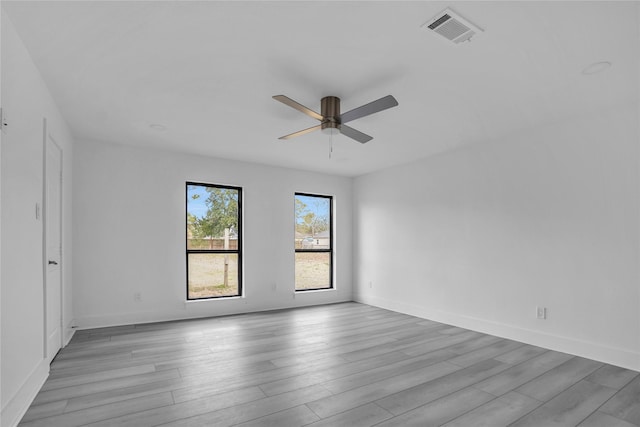 spare room with ceiling fan and light wood-type flooring