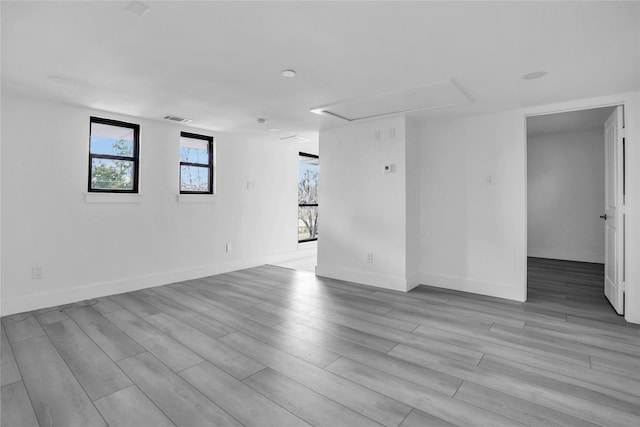 unfurnished room with light wood-type flooring