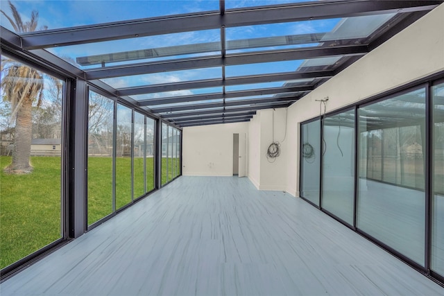 unfurnished sunroom with beamed ceiling