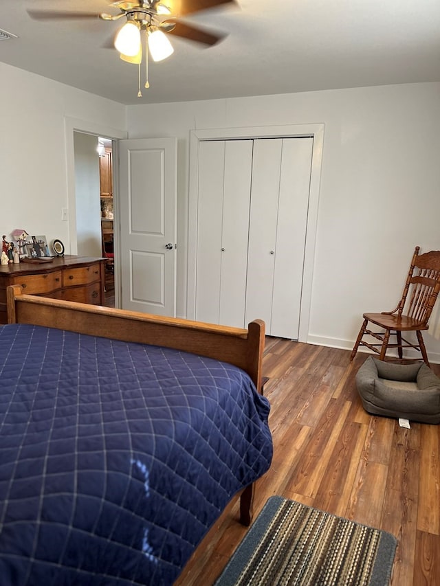 bedroom featuring ceiling fan, wood-type flooring, and a closet