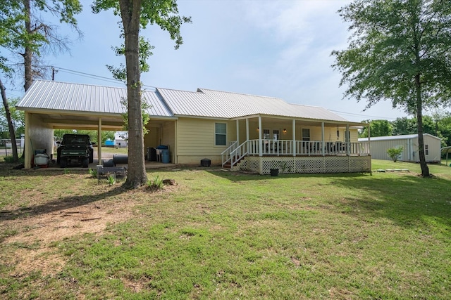 back of house with a carport, a yard, and covered porch