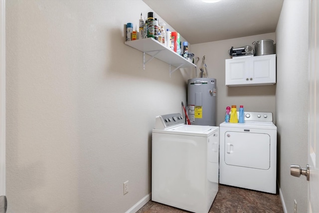 washroom with cabinets, electric water heater, and washer and dryer