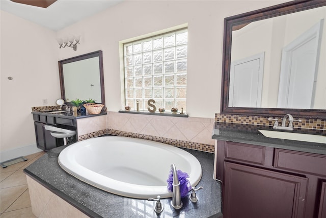 full bathroom featuring backsplash, vanity, a bath, and tile patterned floors