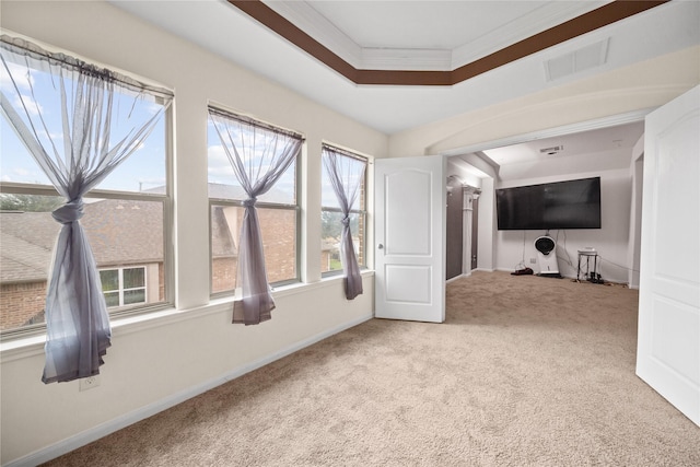 interior space featuring a tray ceiling, visible vents, and baseboards