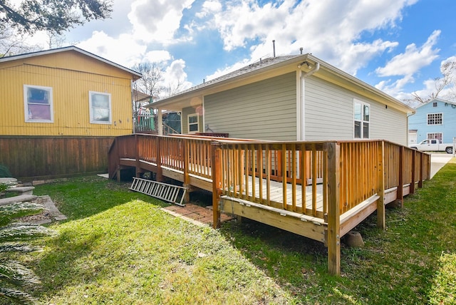 back of property featuring a yard and a deck