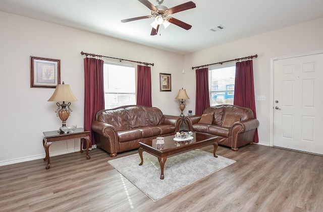 living room with hardwood / wood-style floors and ceiling fan