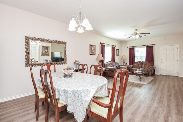 dining room featuring hardwood / wood-style flooring and ceiling fan with notable chandelier