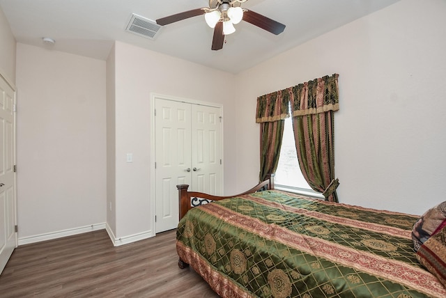 bedroom with ceiling fan, dark hardwood / wood-style flooring, and a closet