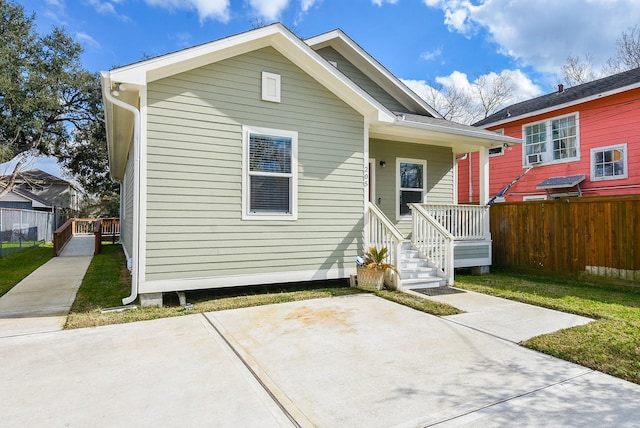 back of property with covered porch and a patio area