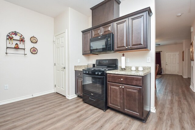 kitchen with light hardwood / wood-style floors, dark brown cabinets, and black appliances