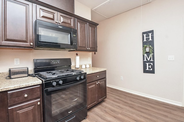 kitchen featuring dark brown cabinets and black appliances