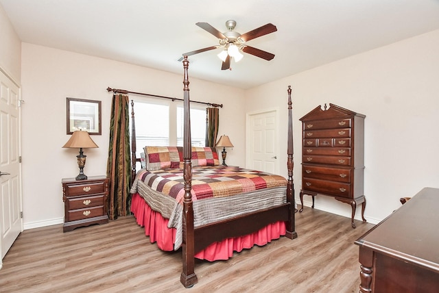 bedroom with light hardwood / wood-style floors and ceiling fan