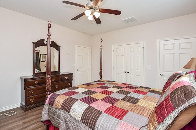 bedroom featuring dark hardwood / wood-style floors, ceiling fan, and a closet