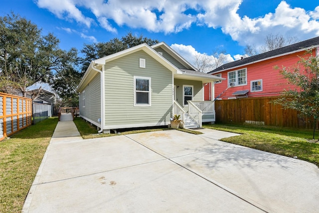 back of property with a porch and a lawn