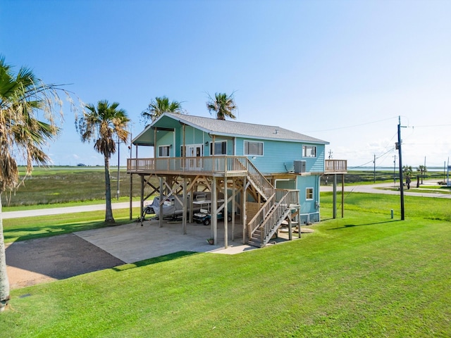 back of property with cooling unit, a carport, and a lawn