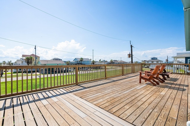 wooden deck with a lawn