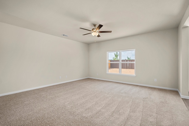 unfurnished room with light colored carpet and ceiling fan