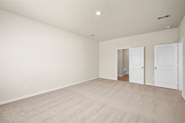 unfurnished bedroom with light colored carpet