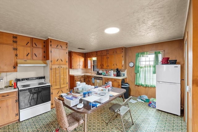 kitchen featuring a textured ceiling and white appliances