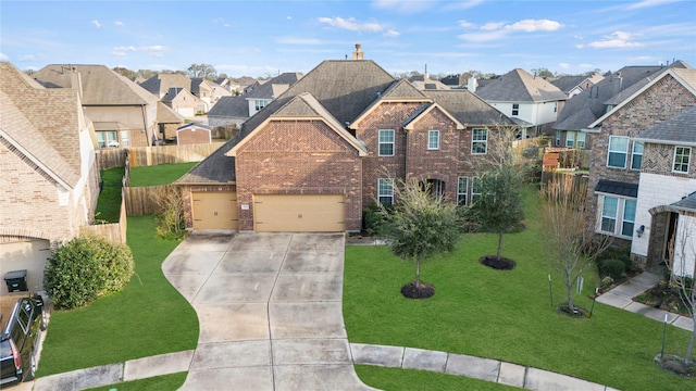 view of front facade with brick siding, fence, driveway, a residential view, and a front yard