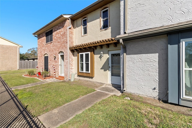 rear view of property with a lawn