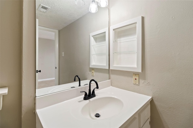 bathroom featuring vanity and a textured ceiling