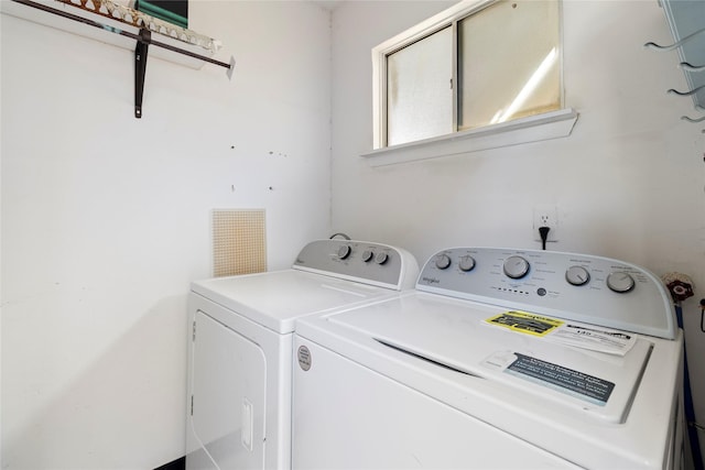 clothes washing area with washing machine and dryer