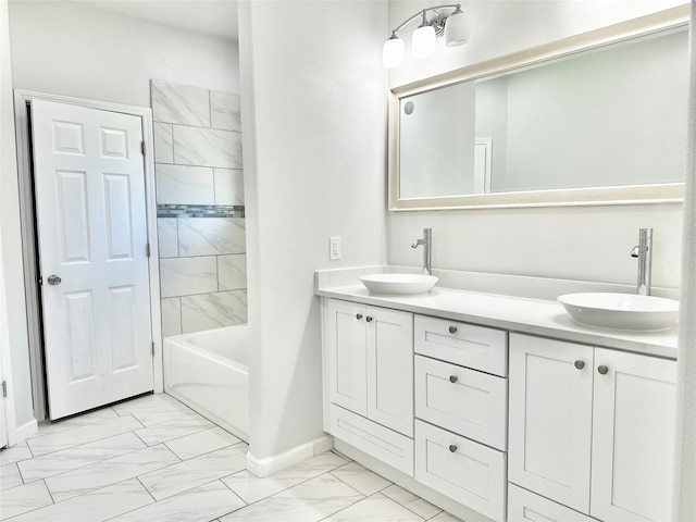 bathroom with vanity and tiled shower / bath