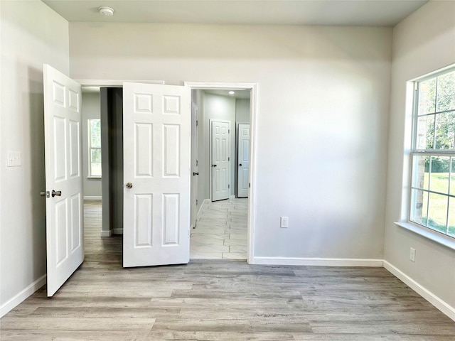 unfurnished bedroom with light wood-type flooring