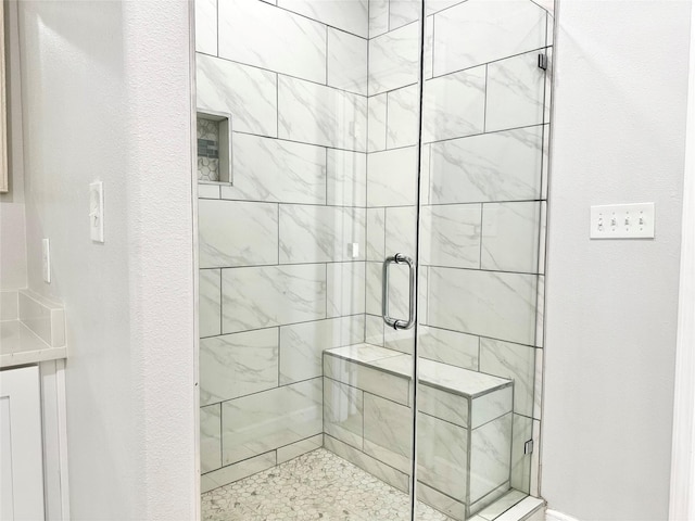 bathroom with a shower with door