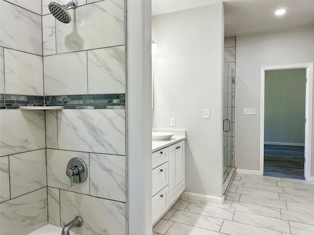 bathroom with walk in shower and vanity