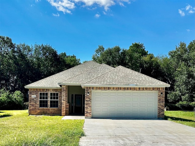 view of front of home with a garage and a front yard