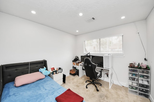 carpeted bedroom with a textured ceiling