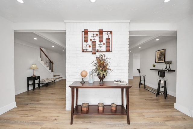 corridor with light hardwood / wood-style flooring