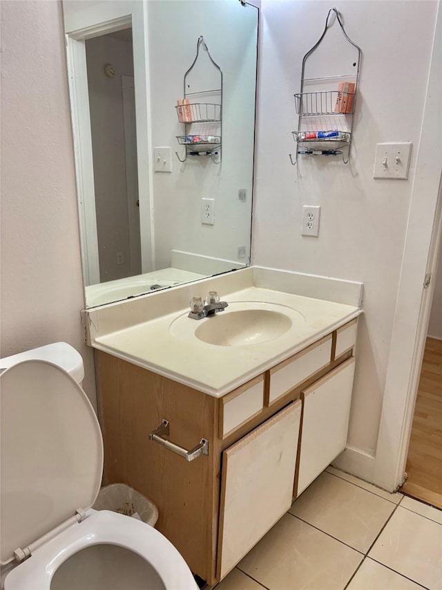 bathroom with vanity, tile patterned floors, and toilet