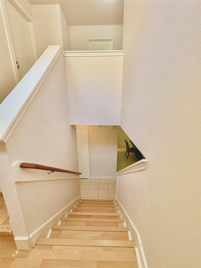 staircase with wood-type flooring