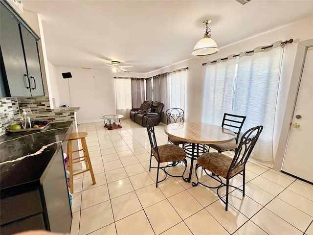 dining space featuring light tile patterned floors and ceiling fan