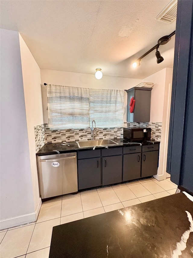 kitchen with tasteful backsplash, sink, stainless steel dishwasher, and a textured ceiling