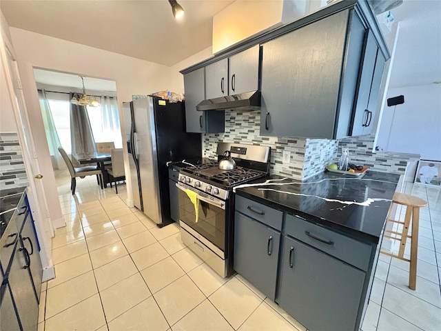 kitchen with decorative light fixtures, light tile patterned floors, appliances with stainless steel finishes, gray cabinets, and backsplash