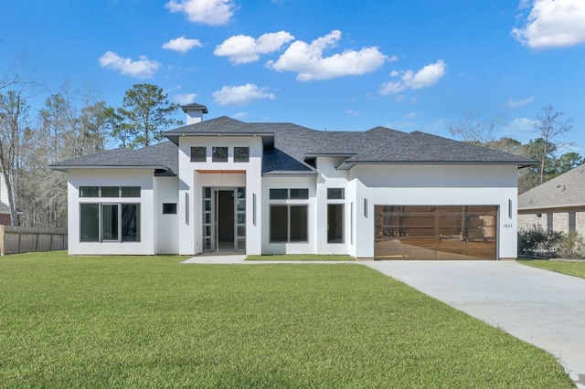 view of front of home with a garage and a front yard