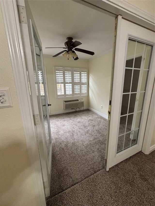 spare room with a wall mounted air conditioner, french doors, ceiling fan, and carpet flooring